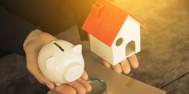 Real estate investment. House and coins on table.