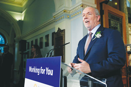 Premier John Horgan answers questions from the media following the speech from the throne in the legislative assembly in Victoria, B.C., on Tuesday, February 13, 2018. THE CANADIAN PRESS/Chad Hipolito