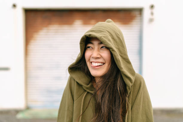 A young woman is making a funny face and sticking out her tongue.